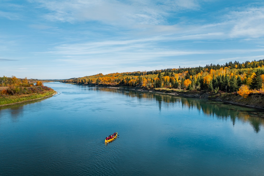 People canoeing on the river in Alberta during fall