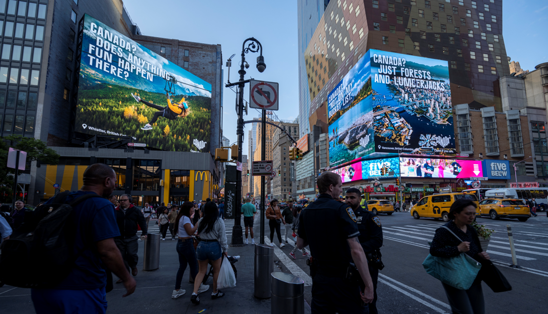 Times Square in New York City showing large digital screens with Canada ads on either side