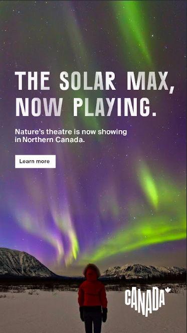A night sky with n A night sky with northern lights and a person standing in the foreground with the following text in the sky: "THE SOLAR MAX, NOW PLAYING. Nature's theatre is now showing in Northern Canada. Learn more"orthern lights and a person standing in the foreground with the following text in the sky: "THE SOLAR MAX, NOW PLAYING. Nature's theatre is now showing in Northern Canada. Learn more"