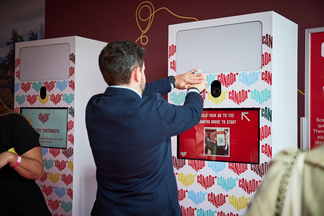 A person interacts with a Canada-branded photobooth