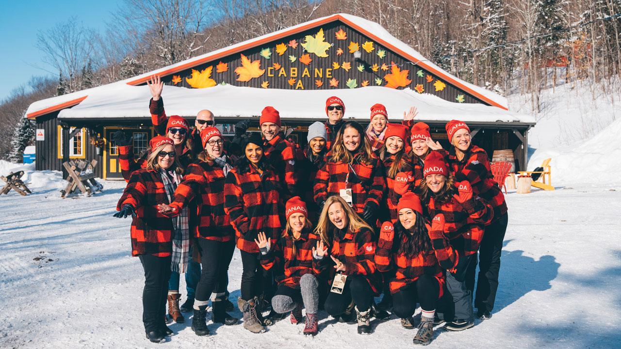 A group photo outside in the snow, in matching red plaid uniforms