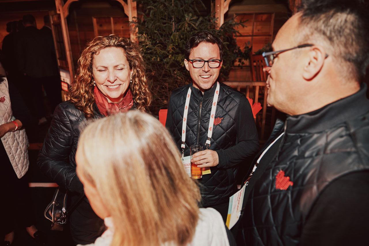 A candid photo of guests wearing branded black vests featuring the glowing hearts logo